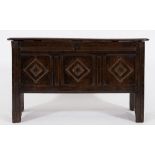 A 17th century oak rectangular coffer: of small size, with a plain hinged moulded top,