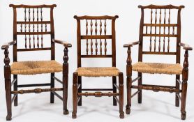 A harlequin set of eight early 19th century fruitwood spindle back dining chairs: with shaped top