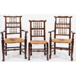 A harlequin set of eight early 19th century fruitwood spindle back dining chairs: with shaped top