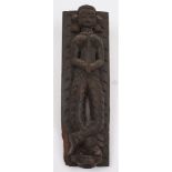 A 19th century central Indian wooden stile with carved figure: in traditional costume with