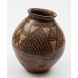 A Chinese Neolithic terracotta jar: of ovoid form with flared rim,