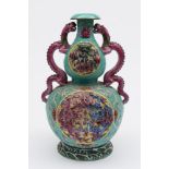 A Chinese double gourd pink dragon vase: with sinuous pink dragon handles with loose eyes,