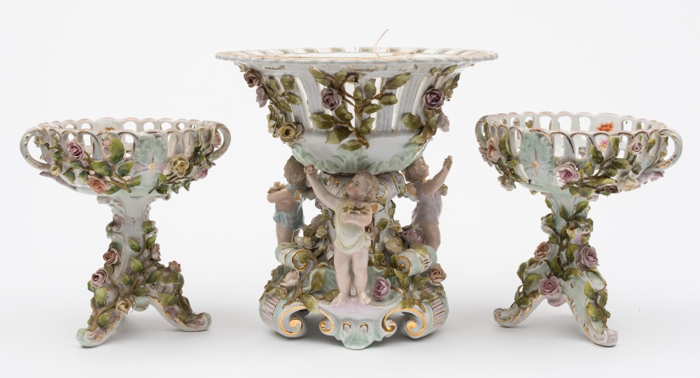 A Sitzendorf porcelain centrepiece and a pair of Dresden pedestal baskets: the centrepiece in the
