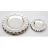 Ten Ecuadorian silver side plates and five butter plates: of circular form with wavy edge borders,