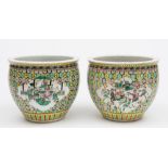 A pair of Chinese famille rose small fish bowls: painted with panels of officials and warriors on a