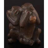 A Japanese carved boxwood okimono of three monkeys 'Hear no evil, See no evil,