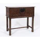 An early 18th century oak rectangular box: on a later stand, having a plain hinged top,