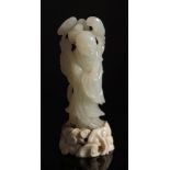 A Chinese carved jade carving of a man holding lingzhi sprays: with smiling expression and wearing