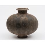 A Chinese pottery cocoon vase: the ovoid body incised with vertical geometric bands,