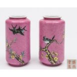 A pair of Chinese pink ground vases: of cylindrical form with short everted rims,