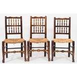 A harlequin set of eight late 18th/early 19th Century ash and fruitwood spindleback dining chairs:,