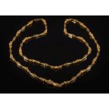 An early 19th century gold long chain necklace: of pierced tapering,