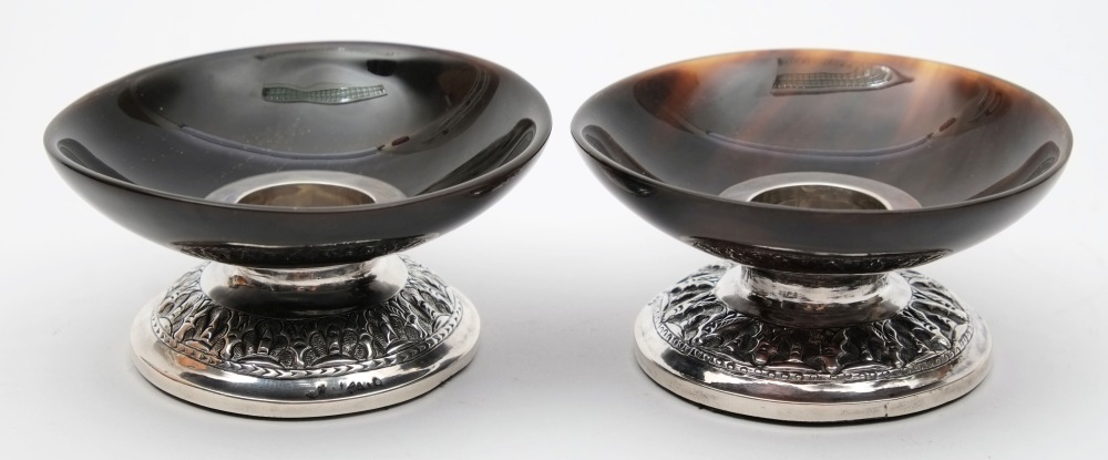 A pair of horn and white metal desk candlesticks: of low circular form with weighted bases, 8cm.
