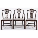 A set of six carved mahogany dining chairs:, in the Hepplewhite taste,