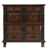 A Jacobean oak and marquetry rectangular chest: in two parts, the top with a moulded edge,