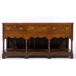 A late 18th / early 19th century oak rectangular dresser base: the top with a reeded moulded edge,