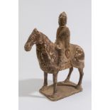 A Chinese painted pottery horse and rider: standing four-square,