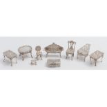 A collection of miniature silver furniture, various makers and dates: including a piano, tables,