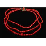 A graduated coral bead three strand necklace: the beads graduated from 3mm diameter to 11mm