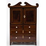 An apprenticeman's early 19th century mahogany and inlaid linen press: bordered with sycamore lines,