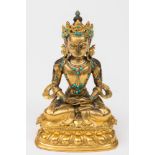 A Burmese gilt-bronze and turquoise mounted study of Buddha: seated cross legged,