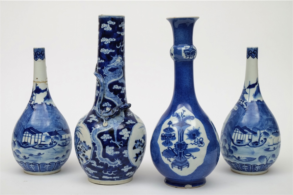 A group of four Chinese blue and white bottle vases: comprising a pair painted with fortified