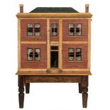 An early 19th century large painted pine dolls house: with green painted simulated tiled pitched