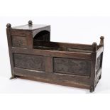 A 17th century carved oak cradle: with a plain canopy,