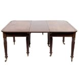 An early 19th century mahogany and inlaid dining table:, the top with rounded corners,