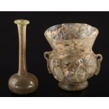 A Byzantine pale green glass lamp and a Roman pale green glass unguentarium: the lamp with central