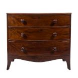 An early 19th century mahogany bow-fronted chest:, the top with a reeded edge,