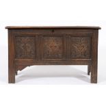 An early 18th century oak rectangular coffer: with a plain hinged moulded top,