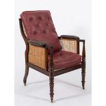 A Regency mahogany bergere armchair: with curved cane panel back, sides and seat,