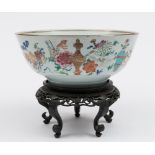 A Chinese porcelain bowl: the interior enamelled in the famille rose palette with peony and
