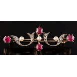 A late 19th century gold, silver, ruby and diamond bar brooch: of openwork scroll design.