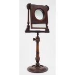 A Victorian mahogany and chequer strung zograscope: with hinged mirror plate and magnifying glass,