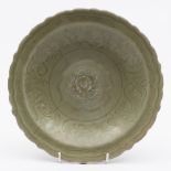 A Chinese Lonquan dish: of shallow form with notched rim,