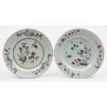 Two Chinese famille rose decorated plates: each decorated with a pair of cockerels in a landscape