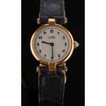 A lady's silver gilt 'Must de Cartier' quartz wristwatch: the circular dial with Arabic numerals