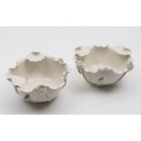 A pair of Chinese blanc de Chine Dehua lotus bowls: in the form of a lotus flower with applied buds,