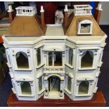 An Edwardian period doll's house: the double hinged front enclosing two ground floor rooms and hall,