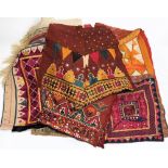 A collection of Indian and Middle Eastern wall hangings:, with stitched geometric decoration.