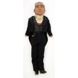 An early 20th century papier mache headed doll of a gentleman in evening dress:,