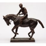 A bronze figure of racehorse with jockey up:, unsigned, on a rectangular base, 54cm high.