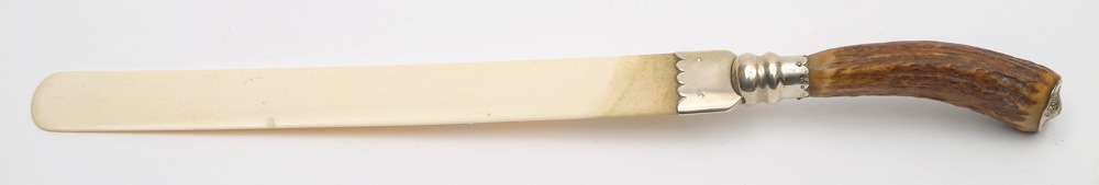 An early 20th century antler handled ivory page turner with silver mount:, makers marks rubbed,