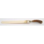 An early 20th century antler handled ivory page turner with silver mount:, makers marks rubbed,