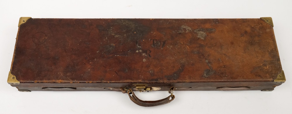 A brass mounted leather gun case by George Bate, Birmingham:, with red lined fitted interior,