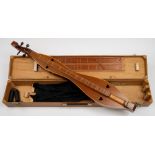 A mahogany dulcimer by F C Bond:, of traditional form with heart shaped sound holes,