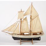 A scale model of a trawler:, fully rigged over planked deck with wheelhouse, davits and lifeboat,