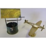 A World War I trench art shell in the form of a wishing well: and a brass model of a Spitfire.